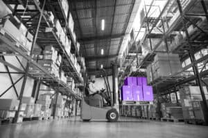 Forklift handling electronics in a spacious warehouse at Banyan Technology, specializing in supply chain solutions and intelligent inventory management.
