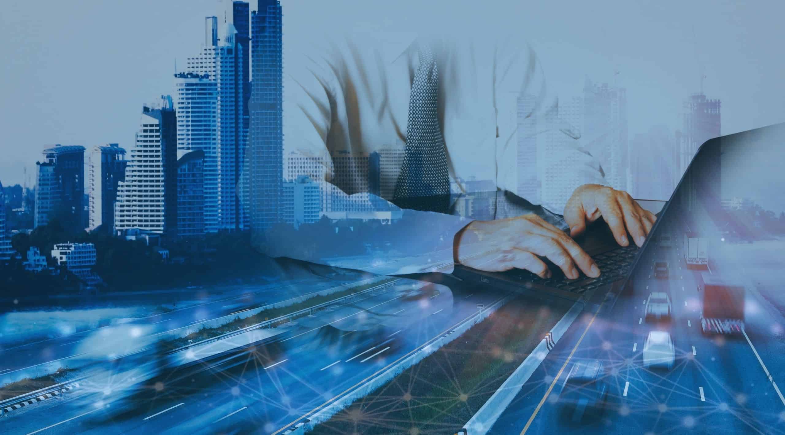 A transportation professional tracking OTR shipment data on a laptop computer