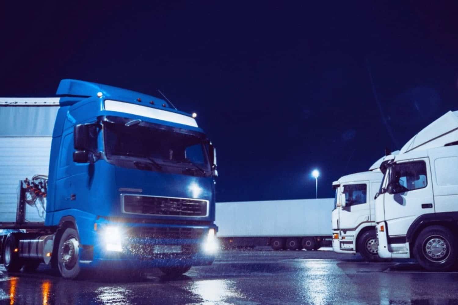 A freight truck entering a shipping facility at night