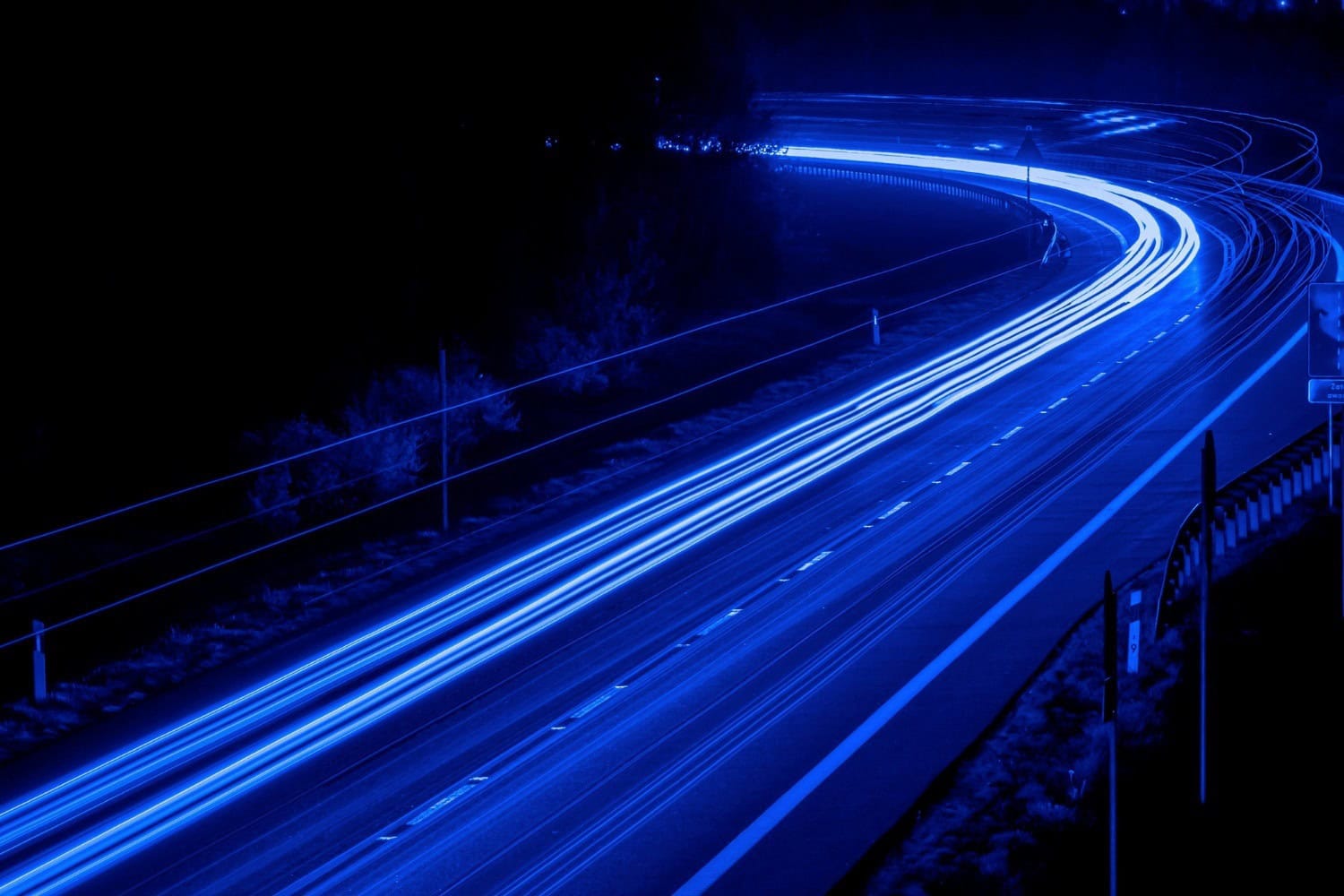 Streaks of vehicle lights captured on a night highway