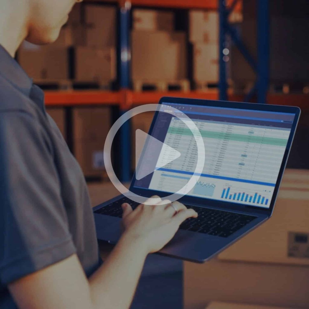 Inventory management software on a laptop in a warehouse environment, showcasing Banyan Technology's logistics and supply chain solutions, order tracking, and real-time data analytics for efficient operations.