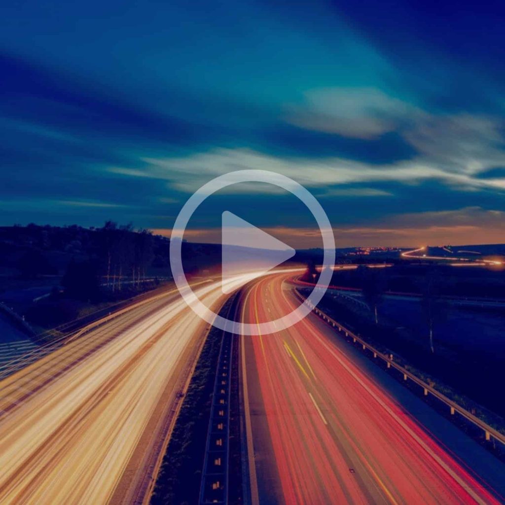 High-speed data transmission on a busy highway at night, representing advanced logistics solutions and technology infrastructure for businesses.