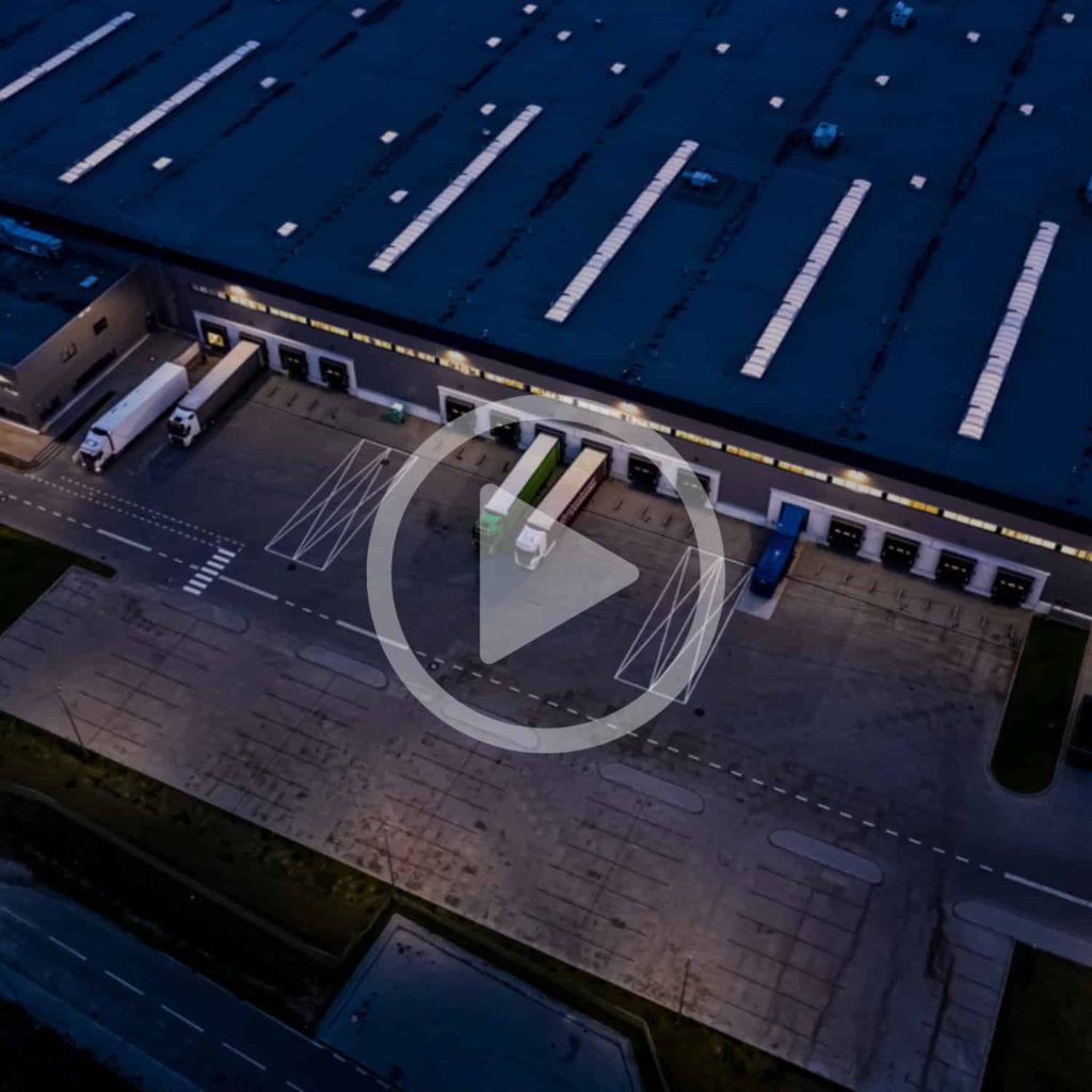Truck logistics warehouse drone delivery distribution center aerial view.