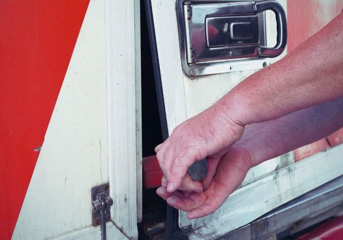 High-resolution image of a technician repairing a communication or utility cabinet, highlighting professional service and technical expertise in infrastructure management.