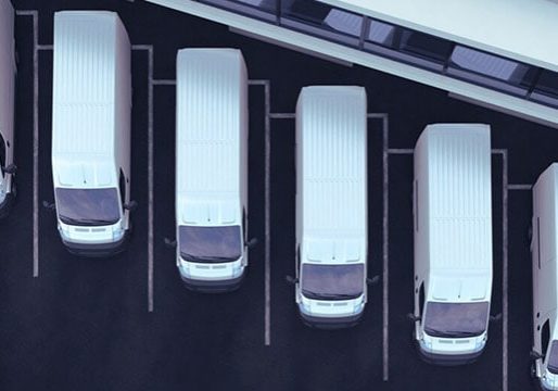 Limited parking lot with white delivery vans, showcasing logistics and fleet management solutions from Banyan Technology.